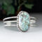 large oval turquoise with brown matrix natural stone bezel set accented with twisted wire and beads on a 3 wire stamped sterling silver cuff